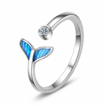Open sterling silver ring with a blue fishtail detail opposite a small clear round accent